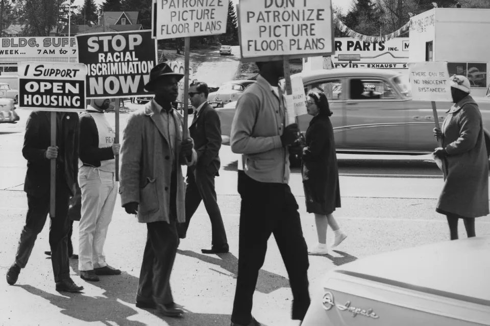People protesting housing discrimination at rally in 1964.